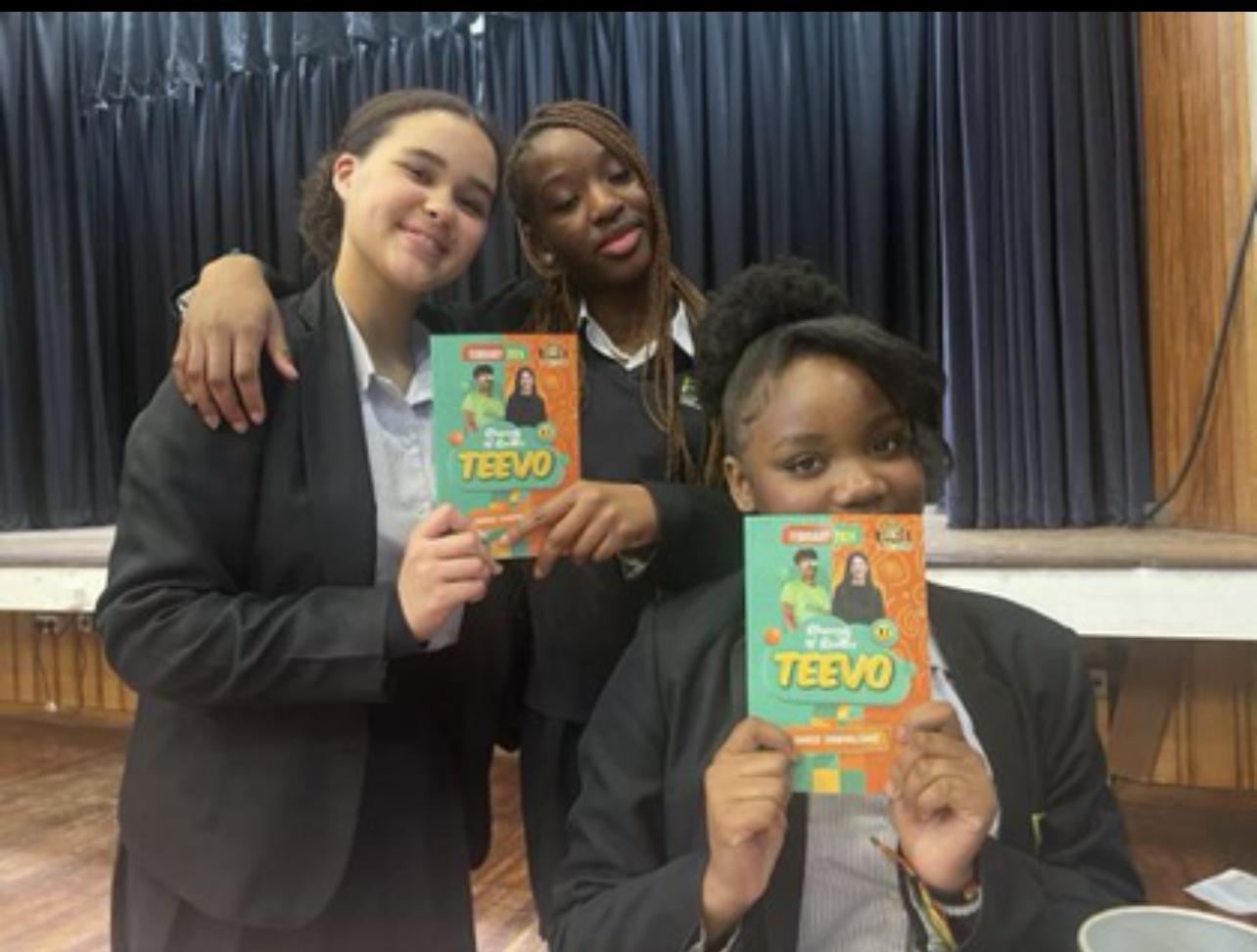 Spark students holding their TeeVo devotionals