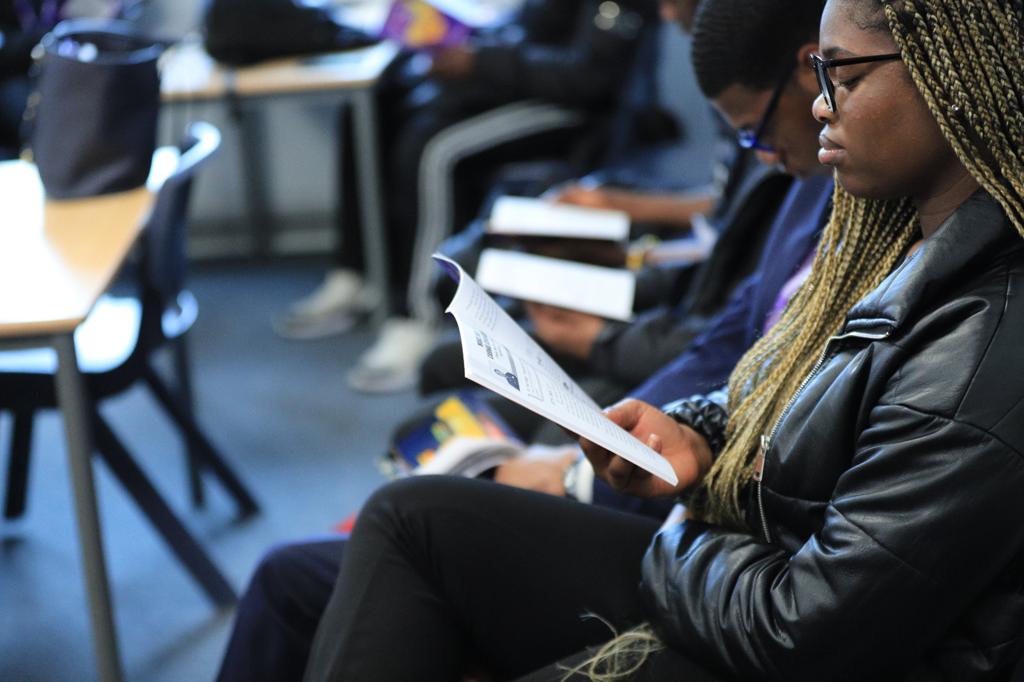 Students reading during a Spark Christian Society session